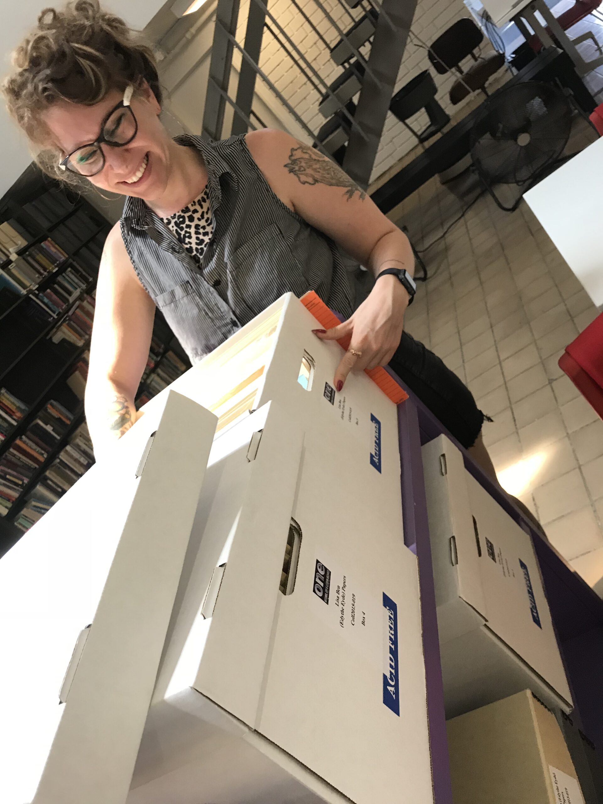 Kate is looking through boxes of Lisa Ben's papers