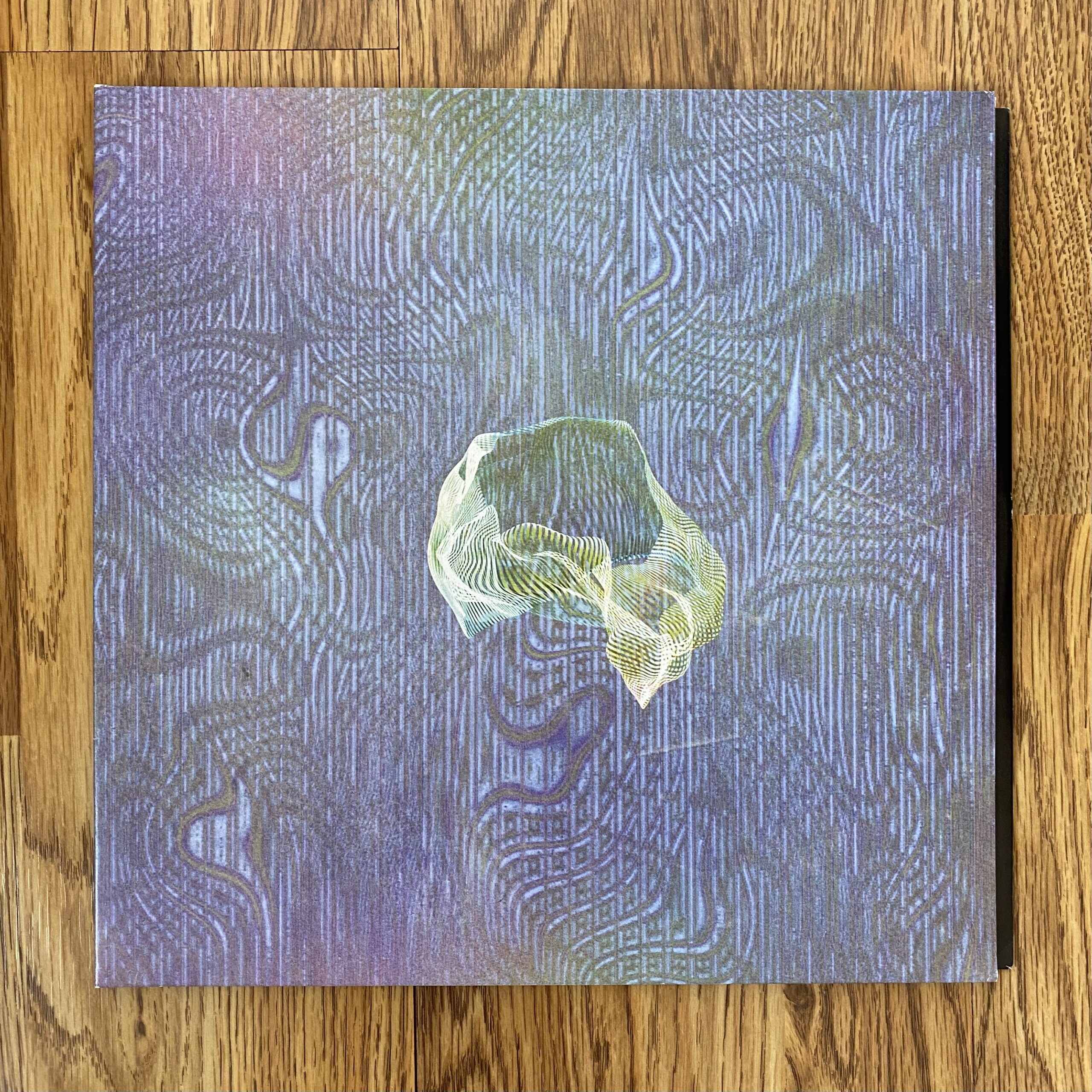 Image Description:A photo of the front cover of "Sudden Anatomy" by Ice Cream Cathedral. The background is an abstract blend of purples, pinks, and blues, and there is an abstract, wavy cream colored drawing at the center of the cover.